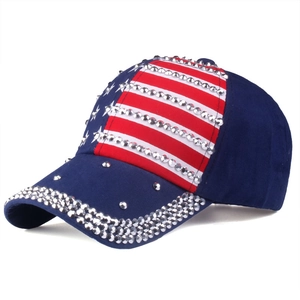 Detailed view of navy blue baseball cap with sparkling rhinestones and US flag pattern