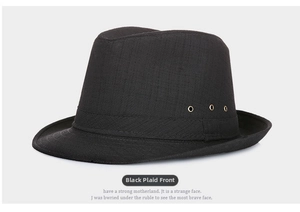 Front view of black checkered fedora hat featuring golden ventilation eyelets