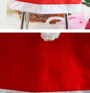 Detail of red non-woven Christmas chair cover with white plush trim and soft fabric texture