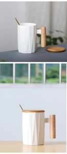 Detailed view of white ceramic mug with wooden handle, matching lid and golden spoon