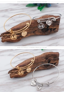 Close-up of gold and silver titanium steel bracelets with Love heart and figure charms