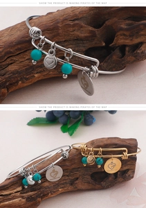 Detail of adjustable charm bracelet with turquoise bead and Happy Mother's Day engraving