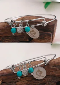 Detail of silver bangle with turquoise beads and Happy Mother's Day heart charm