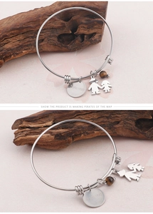 Detail of adjustable silver bangle with 'love you mom' charm and boy-girl pendants