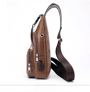 Side view of dark brown PU leather sling bag featuring USB charging port and earphone hole