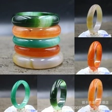 Detailed macro view of assorted natural agate and chalcedony bangles in various colors