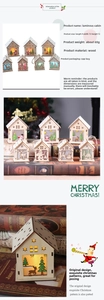 Close-up of LED glowing wooden Christmas house with Santa and reindeer cutout patterns