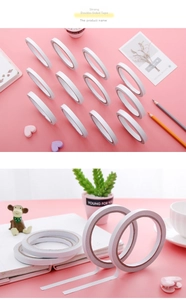 Close-up of double-sided adhesive tape roll used for sticking crafts on a pink desk