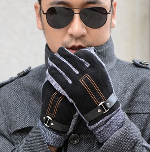 Detail of men's thermal gloves featuring orange stitching, suede texture and metal buckle