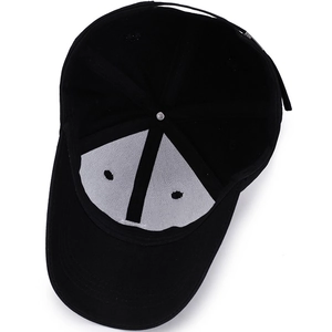 Interior view of black cotton baseball cap showing 6-panel lining and adjustable metal buckle