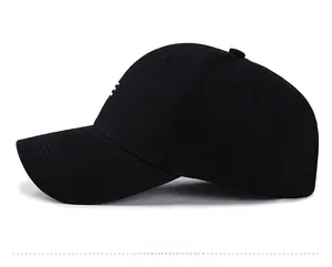 Side view of a classic black cotton baseball cap with curved brim and white embroidery