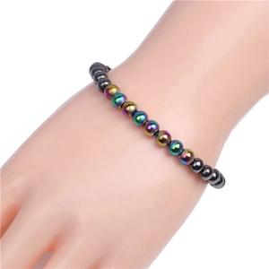 Close-up of 6mm magnetic hematite beads with rainbow metallic coating on a wrist