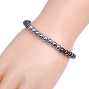 Close-up of 6mm magnetic hematite beads bracelet with glossy metallic finish on wrist