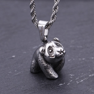Vintage stainless steel panda pendant necklace with twisted chain on a stone surface