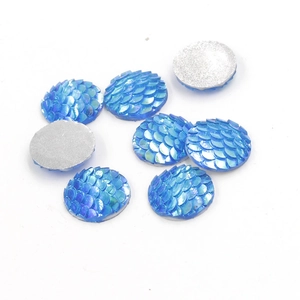 Macro detail of 16mm blue resin fish scale cabochons with sparkling AB finish