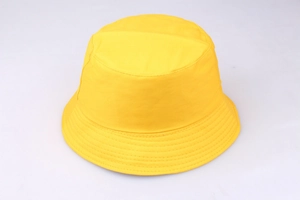 Detail shot of bright yellow canvas bucket hat showing fine stitching and fabric texture
