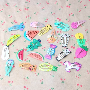 Set of 20 colorful cartoon children's hair clips with fruit and animal shapes on linen