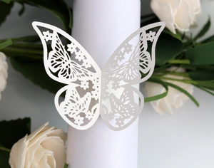 Detailed view of white laser-cut butterfly paper napkin ring for wedding and banquet décor