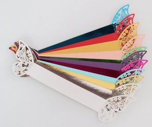 Laser-cut paper napkin rings with butterfly detail in diverse metallic colors