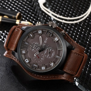 Macro view of the brown leather strap and matte black stainless steel watch case
