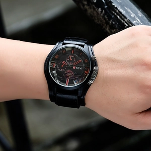 Macro shot of KTEVI men's large black sports watch featuring leather strap and red accents