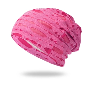 Detailed view of pink knitted cotton beanie with unique distressed hollow mesh texture