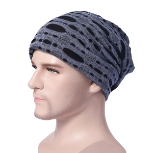 Detail view of the grey and black knitted beanie showing breathable mesh texture and slouchy fit
