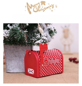 Close-up of a red Santa Mail Christmas tin mailbox for candy gifts on rustic burlap