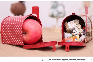 Macro view of Christmas mailbox tins filled with apples and candies for gift storage