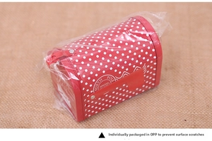 Detailed view of red tinplate mailbox gift box with white dots and North Pole stamp