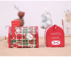 Macro shot of red Christmas tin mailbox candy boxes with Santa Mail and festive patterns