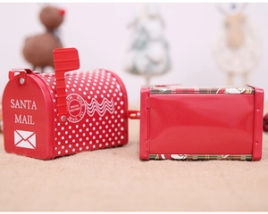 Macro detail of red tinplate Santa mailboxes with white polka dots and festive patterns