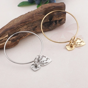 Polished titanium steel love heart bangles for women in gold and silver finishes
