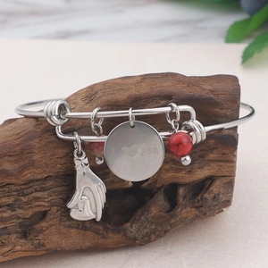 Silver bracelet with red beads, heart charms, and I Love You engraving on wood