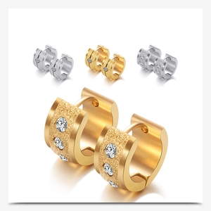 Close-up of 7mm frosted 18K gold earrings with sparkling zircon inlay and hollow design