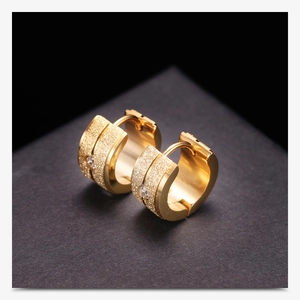 Detail of 18K gold 7mm frosted hoop earrings with central sparkling cubic zirconia