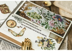 Vintage scrapbooking stickers with botanical butterflies and clock motifs on wood
