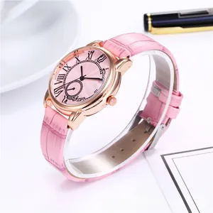 Detail of pink leather quartz watch with Roman numerals and rose gold polished case