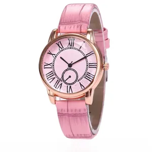 Detail of rose gold watch with pink crocodile leather strap and Roman numeral dial