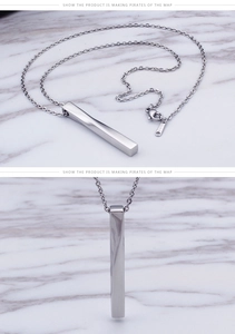 Detailed close-up of a silver stainless steel rectangular bar pendant on a twisted chain