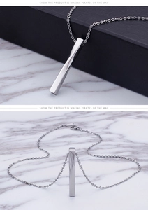 Close-up of polished silver twisted bar pendant necklace on a textured marble background