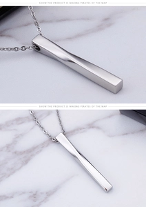 Macro view of men's stainless steel twisted bar pendant with O-chain detail