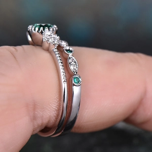 Elegant silver-tone emerald zircon ring set with oval green gemstone and pavé band