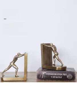 Detail of creative muscle man bookend with antique gold finish and muscle textures