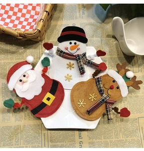 Detailed view of Christmas felt cutlery holders with Santa, Snowman and Reindeer motifs
