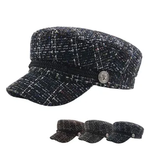 Blue tweed flat top newsboy hat with braided rope trim and silver anchor buttons