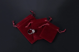 Trio of premium burgundy velvet drawstring gift pouches in small medium and large sizes