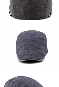 Detailed view of dark grey linen beret with adjustable metal buckle and striped lining