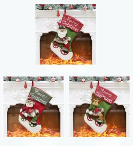 Detail of Christmas stockings with Santa, Snowman, and Reindeer designs on a fireplace