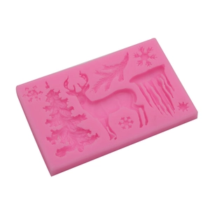 Pink silicone mold with Christmas tree, reindeer, and snowflake shapes for baking
